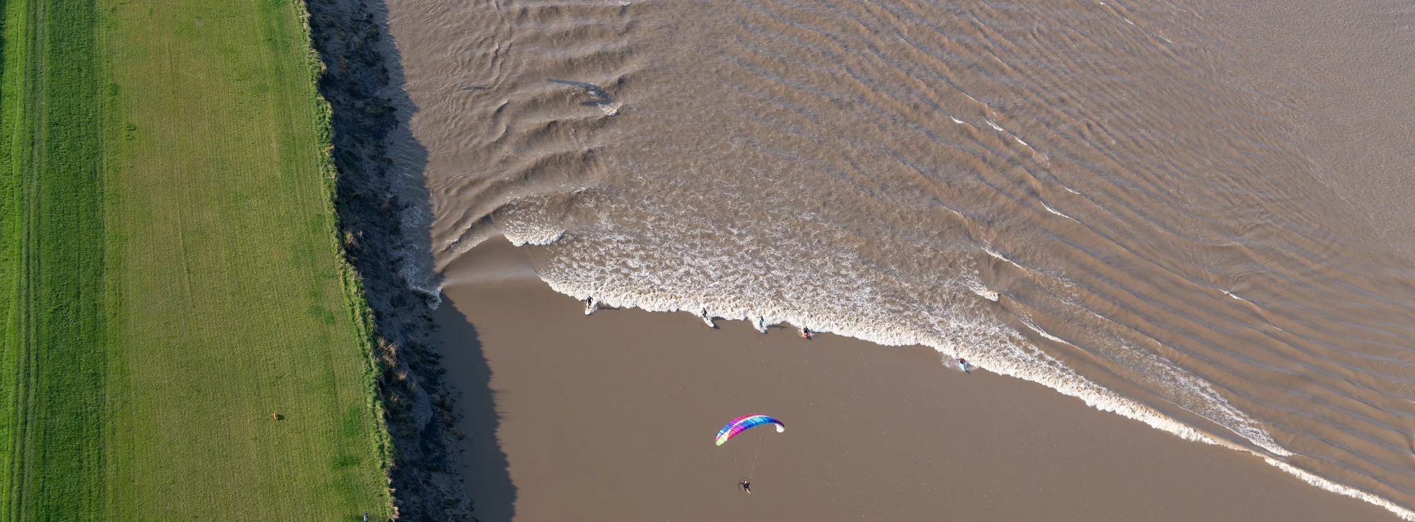 Paramotor flying over scenic landscape